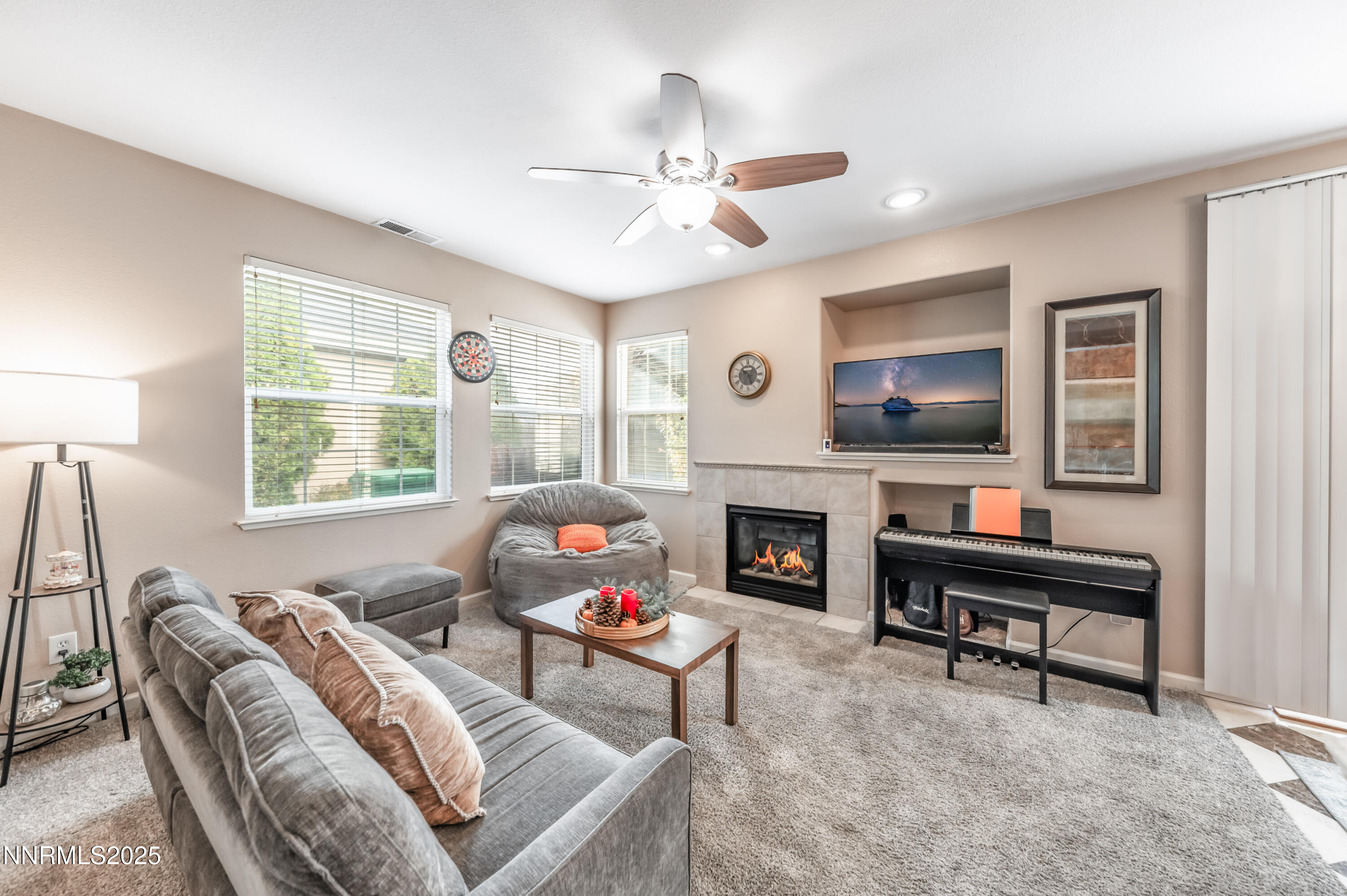 5722 Golden Eagle Drive Reno, NV 89523 - Photo 7 of 32 a living room with furniture a fireplace and a flat screen tv