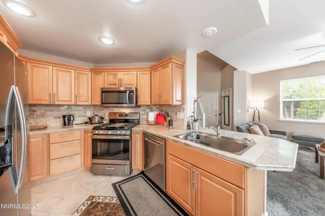 a kitchen that has a sink and a stove in it