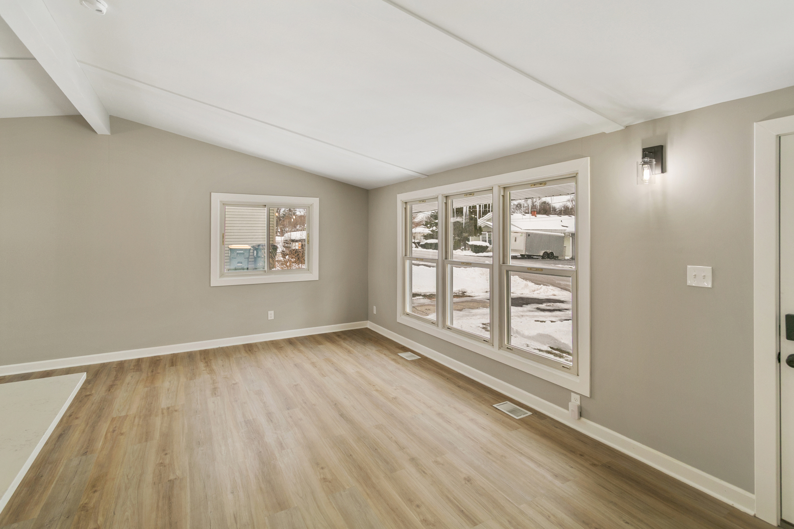 6305 Robert Road Cary, IL 60013 - Photo 9 of 24 an empty room with wooden floor and windows