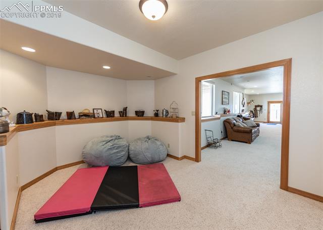 6925 Forestgate Road Colorado Springs, CO 80908 - Photo 30 of 36 Rec room with family room beyond