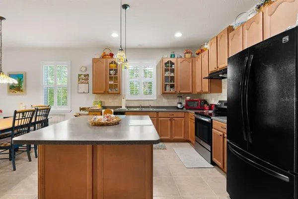 a kitchen with a refrigerator and a sink