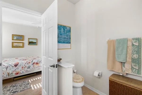 a bathroom with a sink toilet and shower curtain