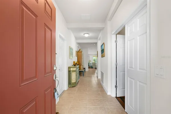 a view of a hallway with wooden floor and windows