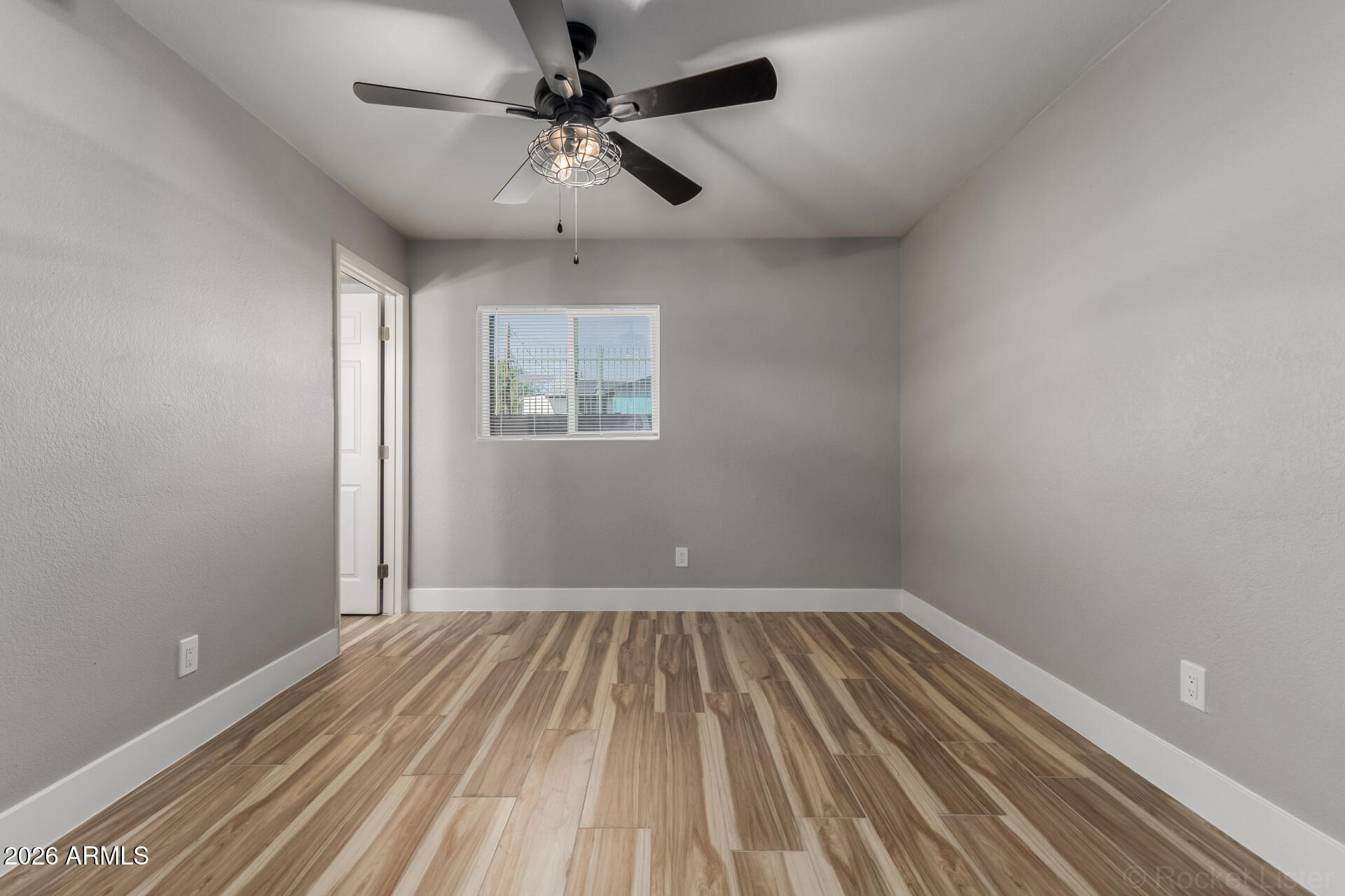 214 East Ruth Avenue, Unit 109 Phoenix, AZ 85020 - Photo 13 of 26 a view of a room with wooden floor and ceiling fan