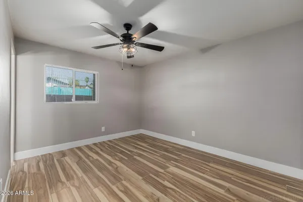 a view of room with window and ceiling fan