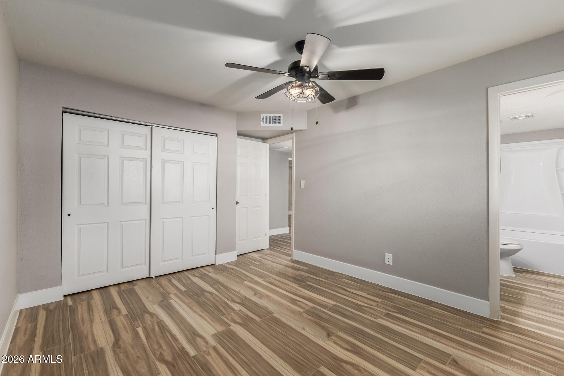 214 East Ruth Avenue, Unit 109 Phoenix, AZ 85020 - Photo 15 of 26 a view of an empty room with wooden floor