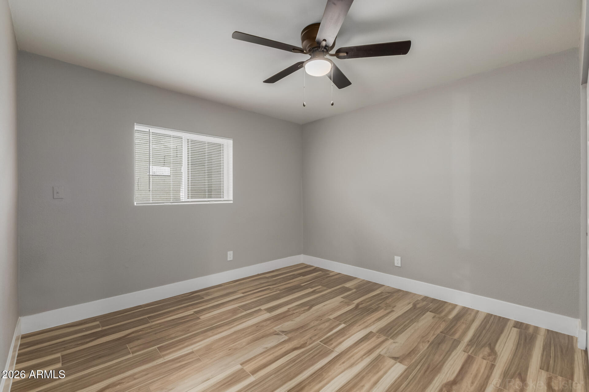 214 East Ruth Avenue, Unit 109 Phoenix, AZ 85020 - Photo 18 of 26 an empty room with a window and a fan