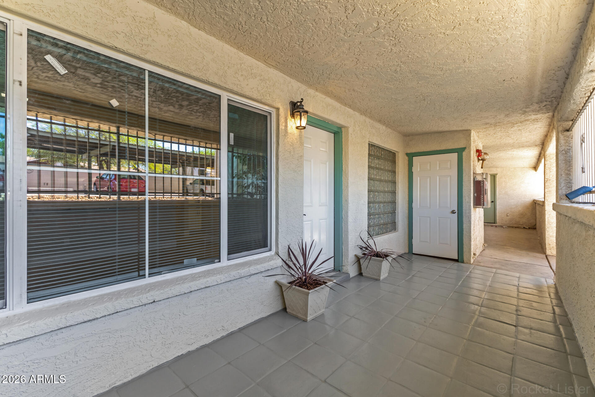 214 East Ruth Avenue, Unit 109 Phoenix, AZ 85020 - Photo 2 of 26 a view of a porch with a table and chairs