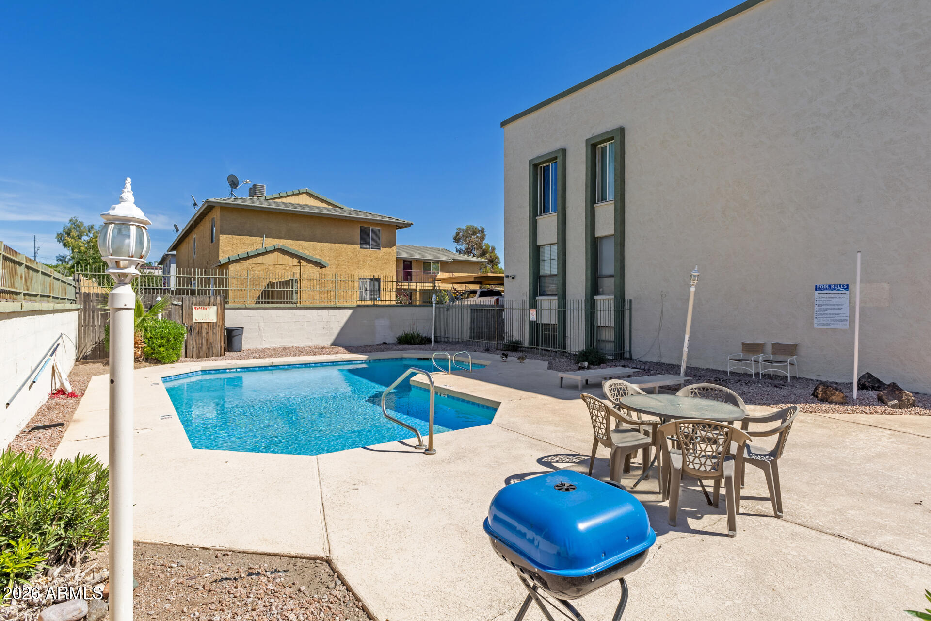 214 East Ruth Avenue, Unit 109 Phoenix, AZ 85020 - Photo 24 of 26 a swimming pool with outdoor seating and yard