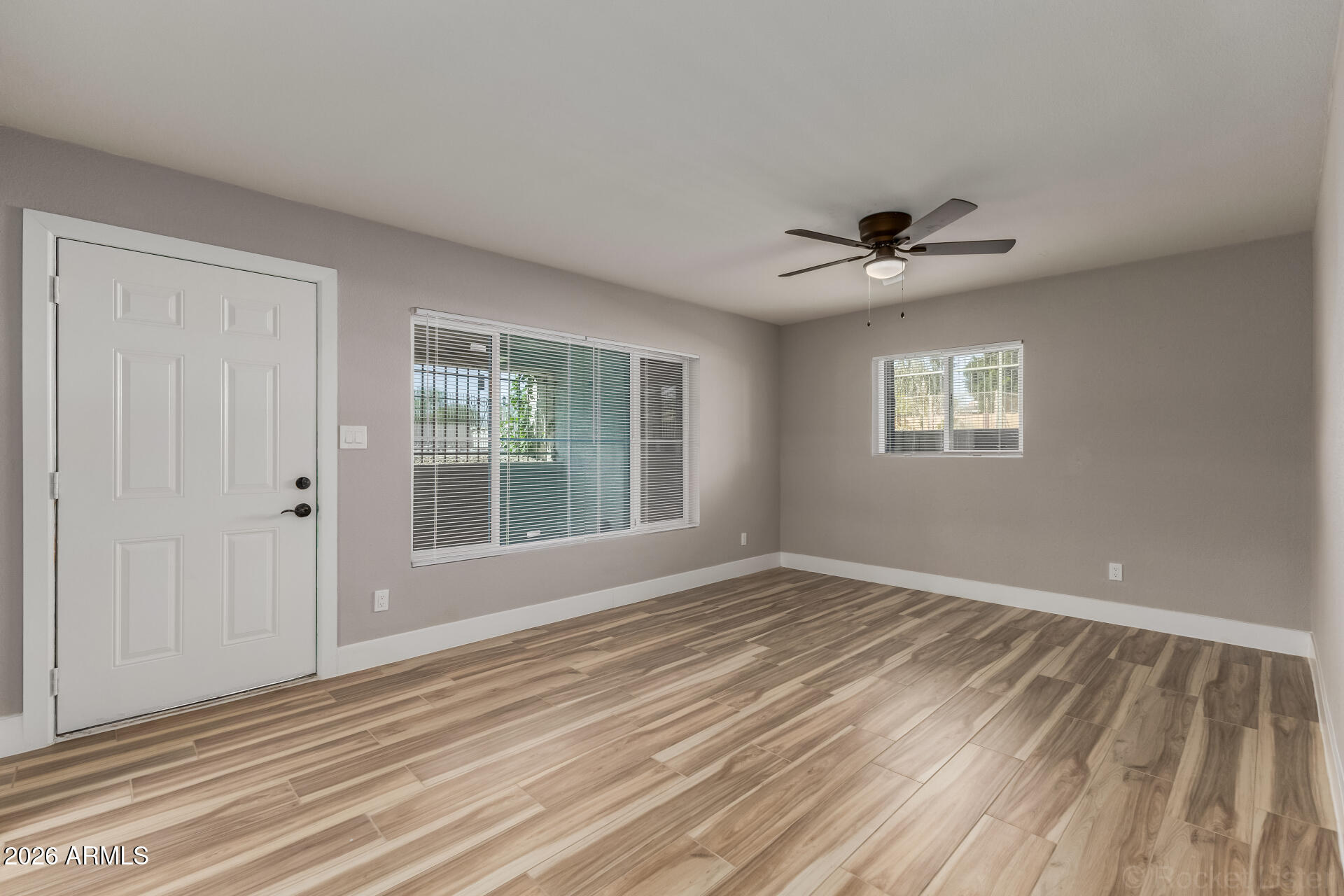 214 East Ruth Avenue, Unit 109 Phoenix, AZ 85020 - Photo 5 of 26 a view of an empty room with a window and a kitchen