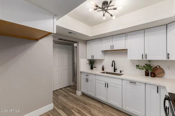 a kitchen with a sink cabinets and window