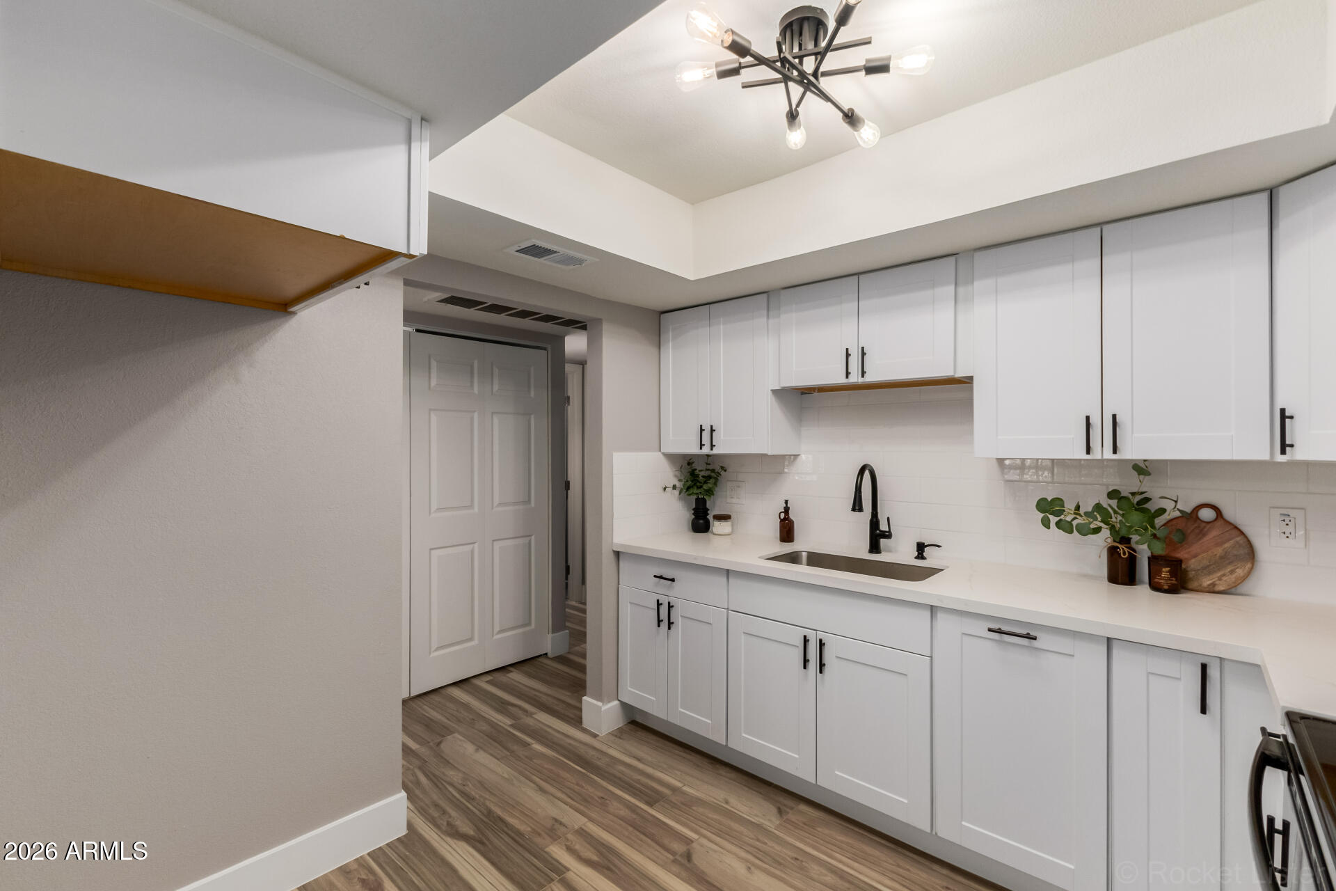 214 East Ruth Avenue, Unit 109 Phoenix, AZ 85020 - Photo 8 of 26 a kitchen with a sink cabinets and window