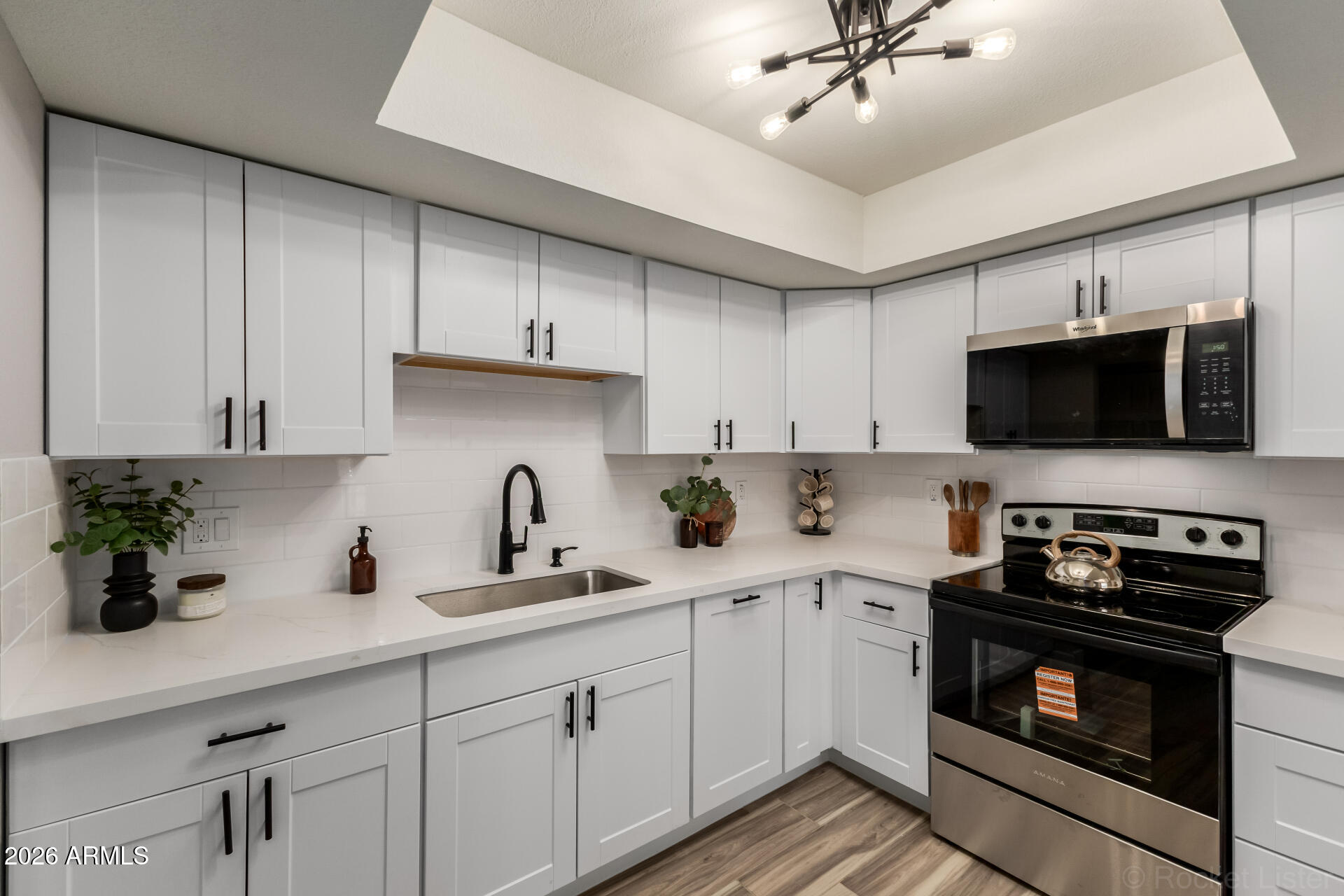 214 East Ruth Avenue, Unit 109 Phoenix, AZ 85020 - Photo 10 of 26 a kitchen with a sink a microwave and cabinets