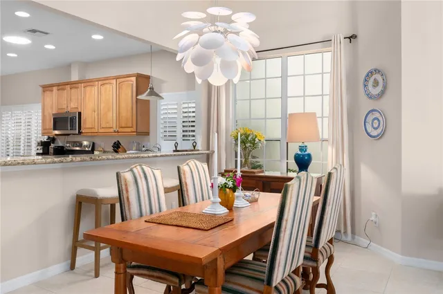 a kitchen with stainless steel appliances granite countertop white cabinets sink and window