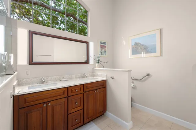 a bathroom with a tub a sink and a window