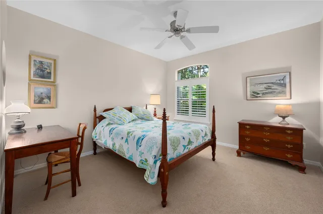 a bedroom with bed and a chandelier