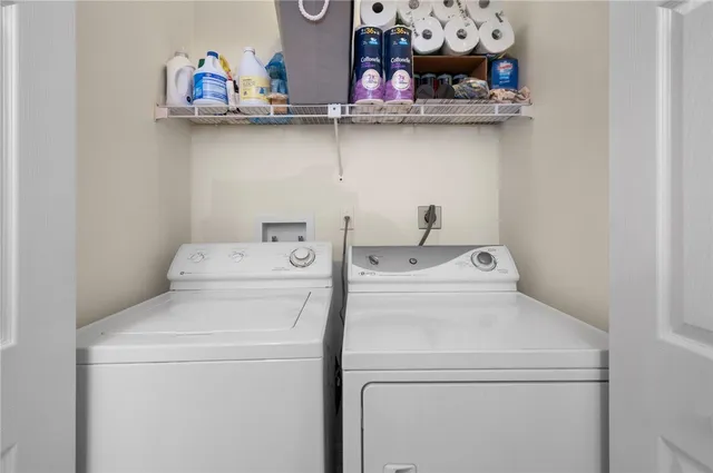 an aerial view of residential house with outdoor space and trees all around