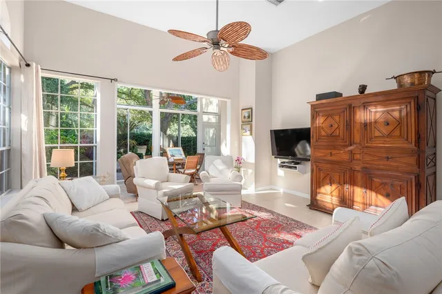 a living room with furniture ceiling fan and a rug