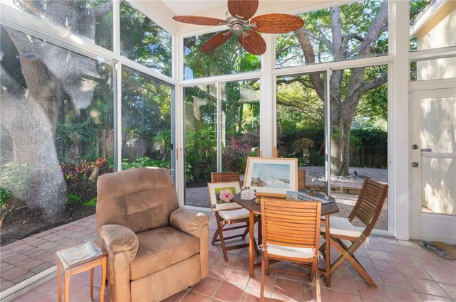 a living room with furniture and flowers