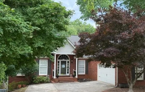front view of a house with a tree