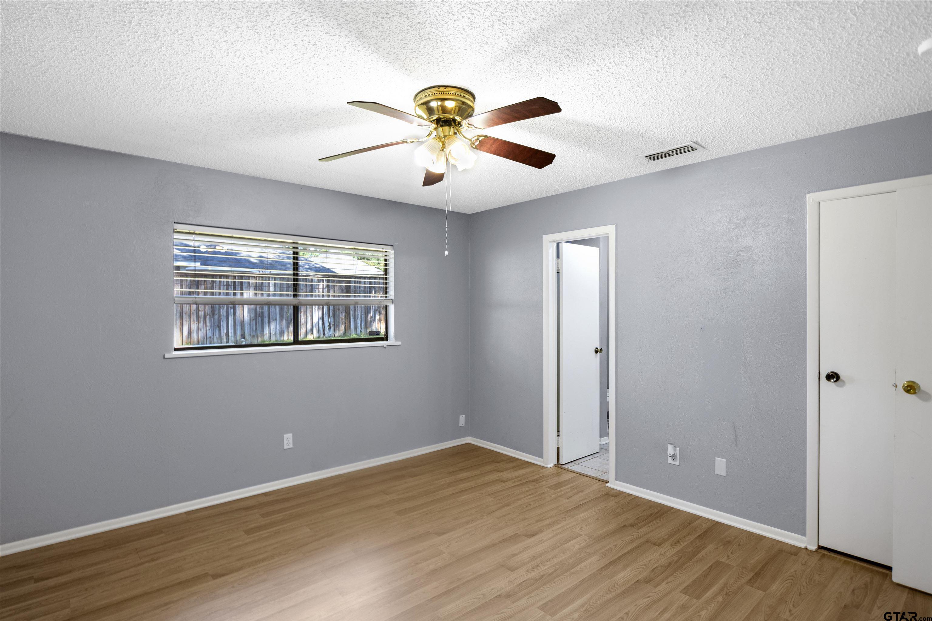 206 Walter Street Longview, TX 75603 - Photo 13 of 17 a view of an empty room with window and wooden floor