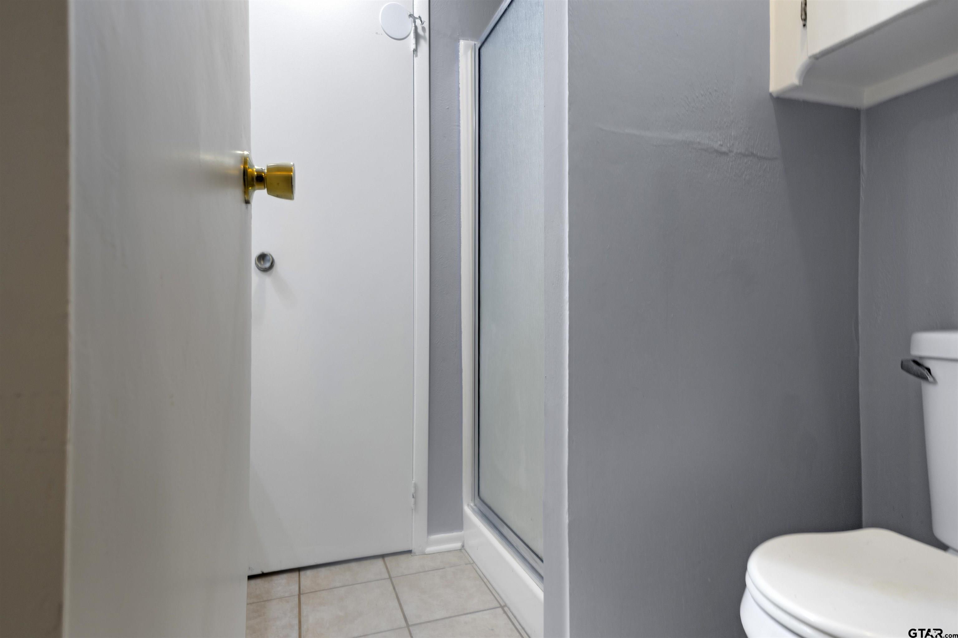 206 Walter Street Longview, TX 75603 - Photo 16 of 17 a white toilet sitting next to a shower