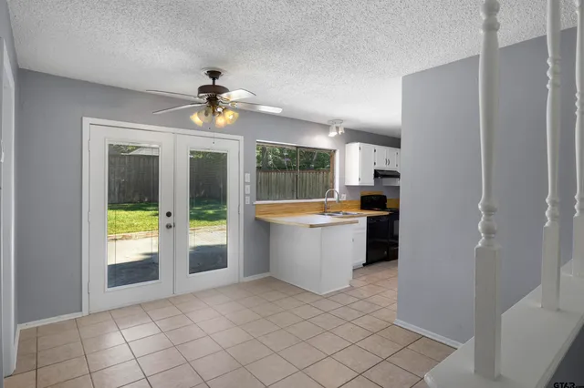 a kitchen with granite countertop a refrigerator and a stove