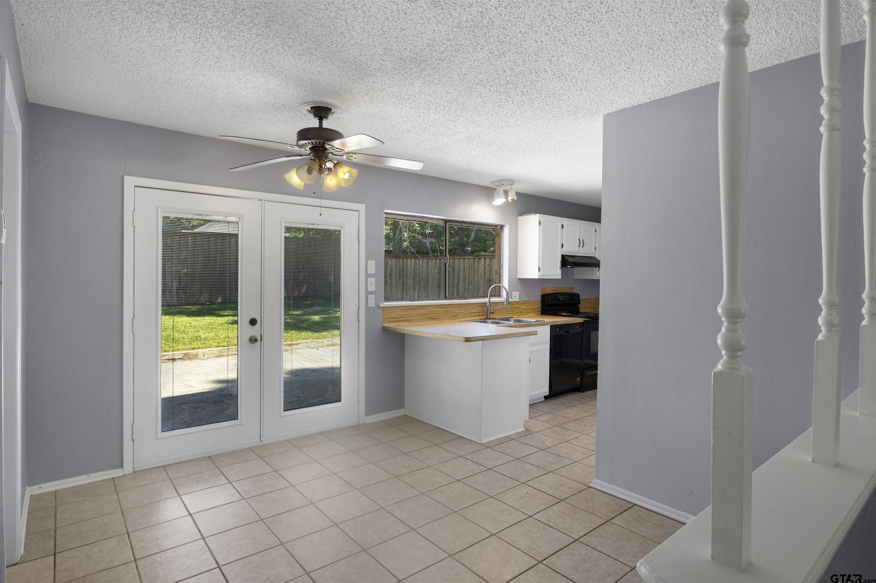 206 Walter Street Longview, TX 75603 - Photo 3 of 17 a kitchen with granite countertop a refrigerator and a stove