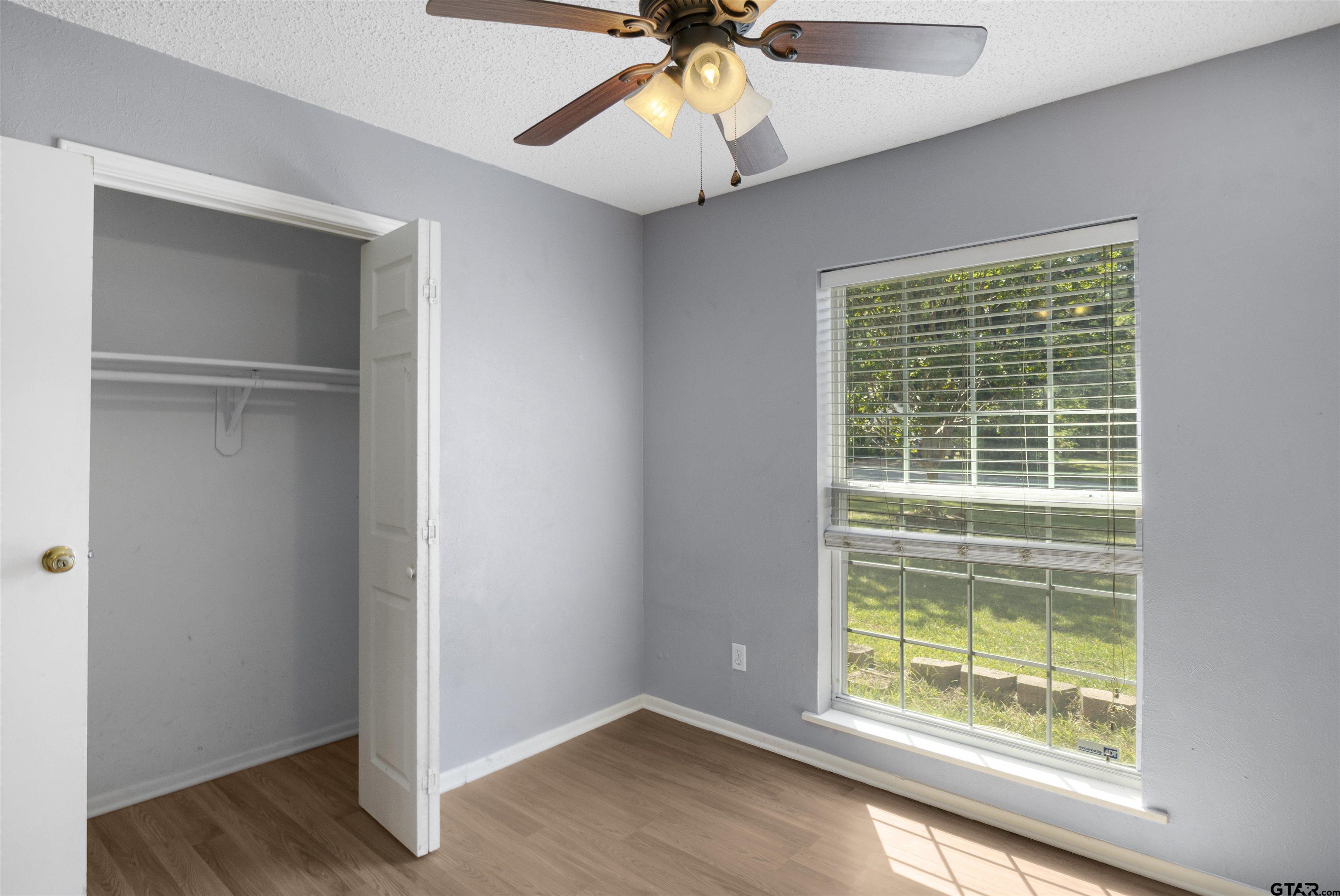206 Walter Street Longview, TX 75603 - Photo 10 of 17 a view of an empty room with wooden floor and a window