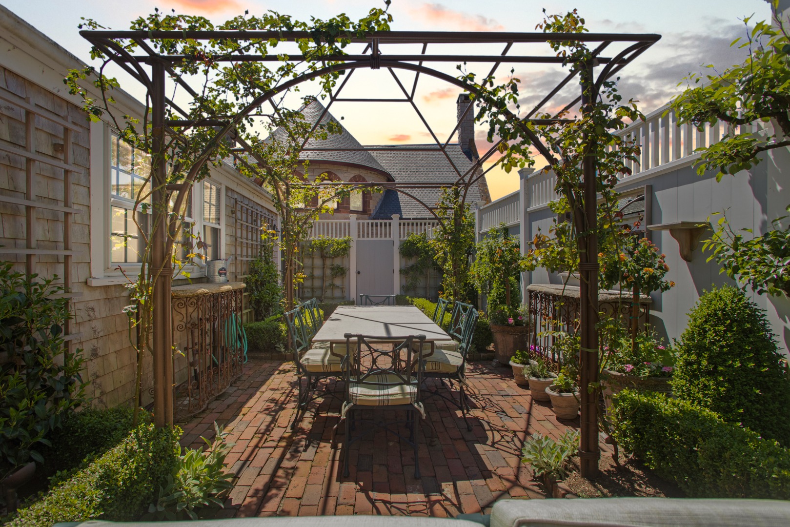 19 Orange Street Nantucket, MA 02554 - Photo 62 of 85 a view of a patio with table and chairs and potted plants