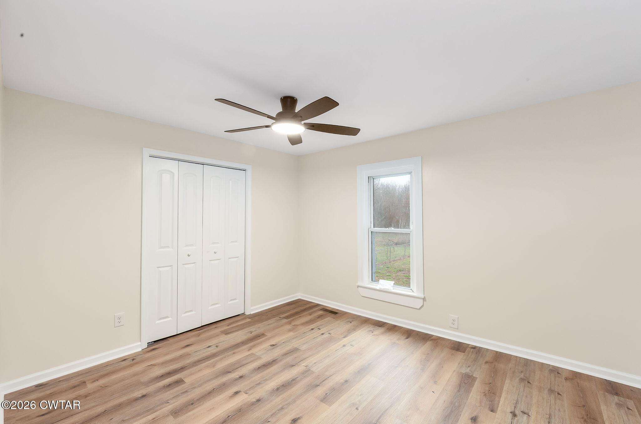 28 Mt Orange Road Trenton, TN 38382 - Photo 14 of 31 an empty room with wooden floor and windows