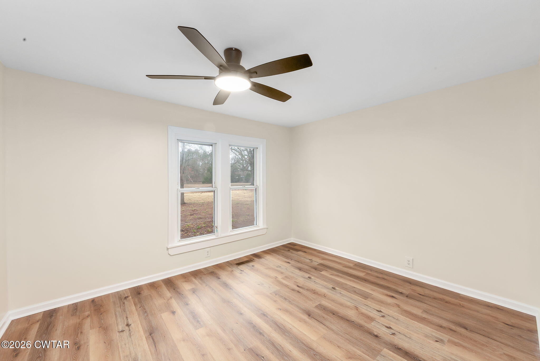 28 Mt Orange Road Trenton, TN 38382 - Photo 15 of 31 an empty room with wooden floor and windows