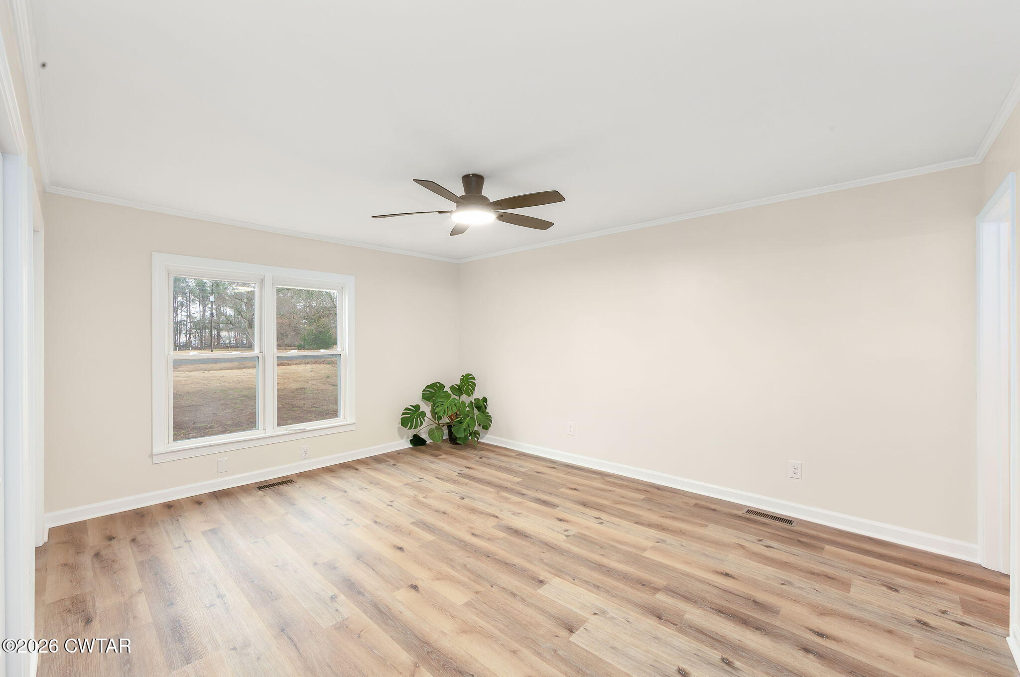 28 Mt Orange Road Trenton, TN 38382 - Photo 18 of 31 a view of an empty room with a window and wooden floor