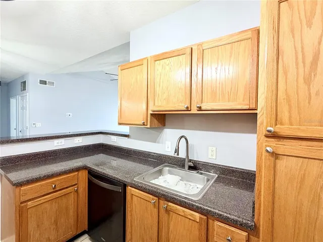 a bathroom with a sink a toilet a mirror and shower