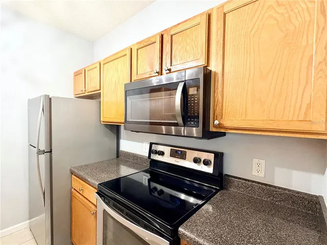 a bathroom with a granite countertop sink toilet a mirror and shower