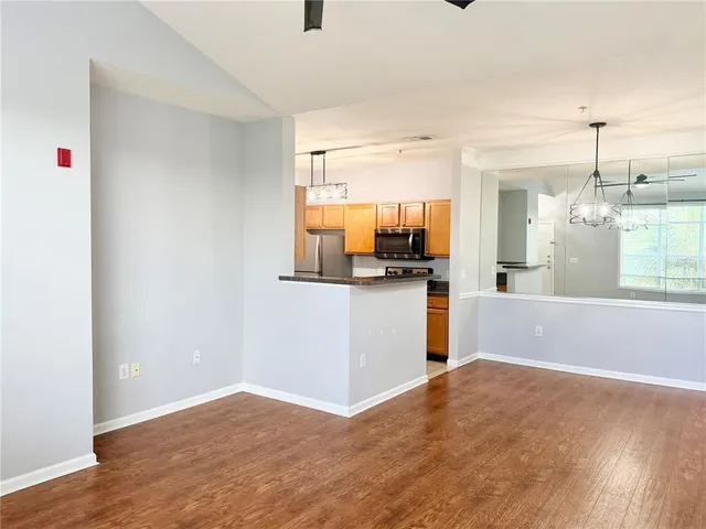 a kitchen with stainless steel appliances granite countertop a stove and a microwave