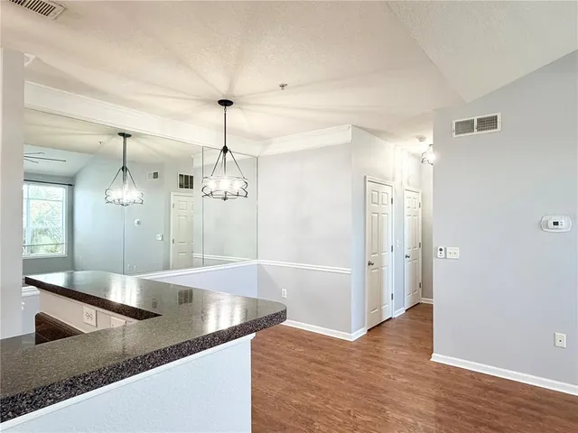 a view of an empty room and a ceiling fan