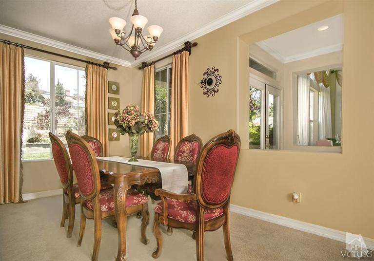 239 Knoll Ridge Road Simi Valley, CA 93065 - Photo 12 of 61 a dining room with furniture a large window and a chandelier