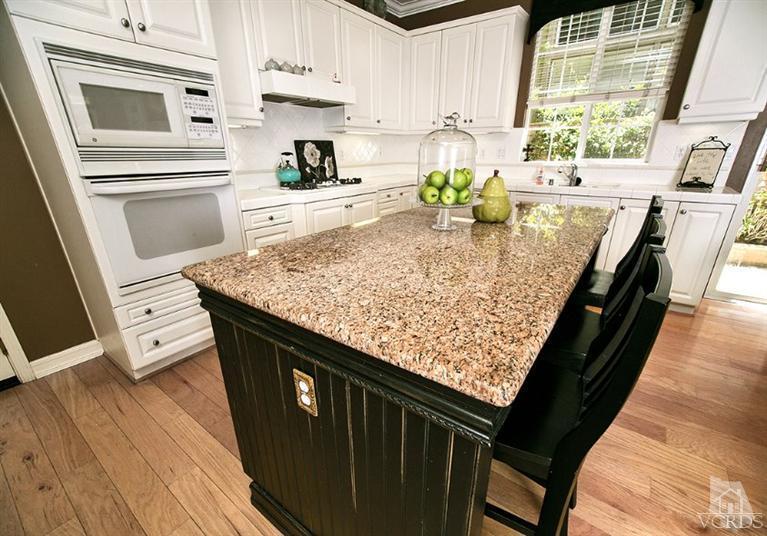 239 Knoll Ridge Road Simi Valley, CA 93065 - Photo 24 of 61 a kitchen with stainless steel appliances granite countertop a sink stove and refrigerator