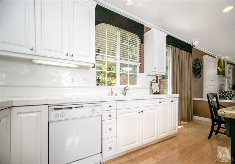 239 Knoll Ridge Road Simi Valley, CA 93065 - Photo 26 of 61 a kitchen with granite countertop white cabinets and white appliances