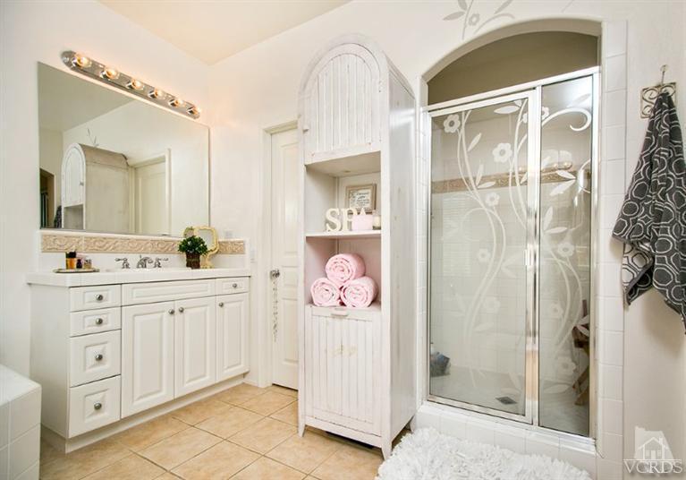 239 Knoll Ridge Road Simi Valley, CA 93065 - Photo 35 of 61 a spacious bathroom with a shower a sink and a mirror