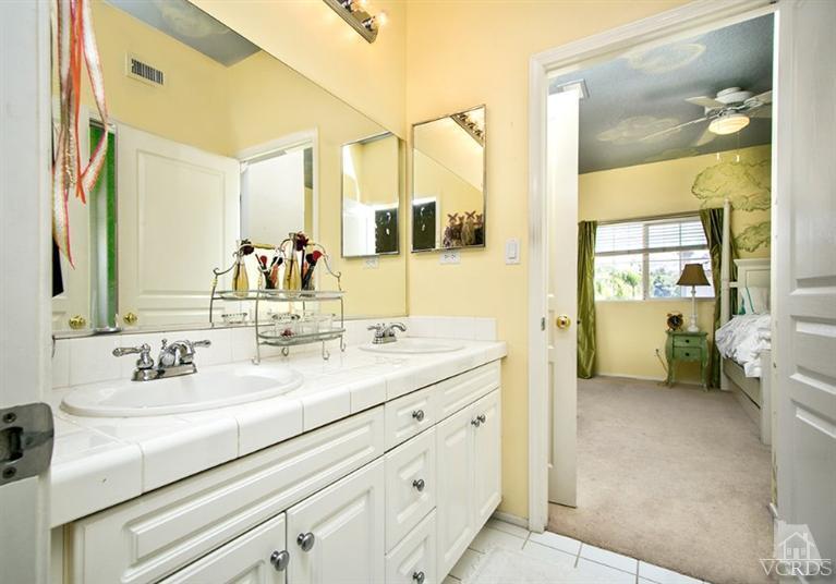 239 Knoll Ridge Road Simi Valley, CA 93065 - Photo 37 of 61 a en suite bathroom with a sink double vanity and a mirror