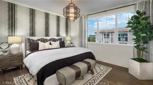 a bedroom with a large bed and a potted plant