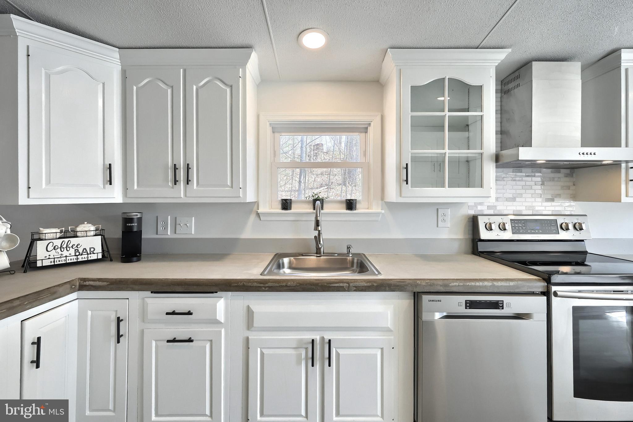 1320 Erney Road Dover, PA 17315 - Photo 19 of 35 a kitchen with stainless steel appliances granite countertop a sink and a stove