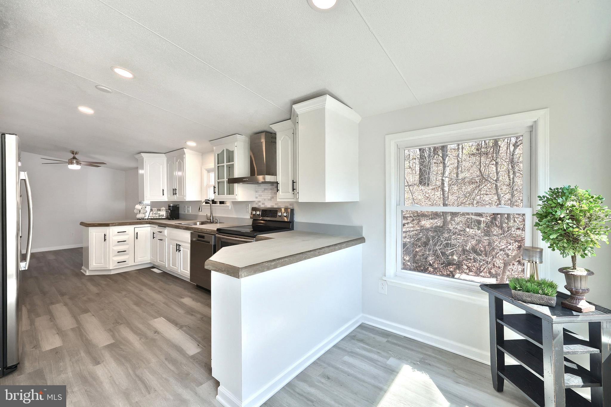 1320 Erney Road Dover, PA 17315 - Photo 21 of 35 a kitchen with white cabinets and wooden floor