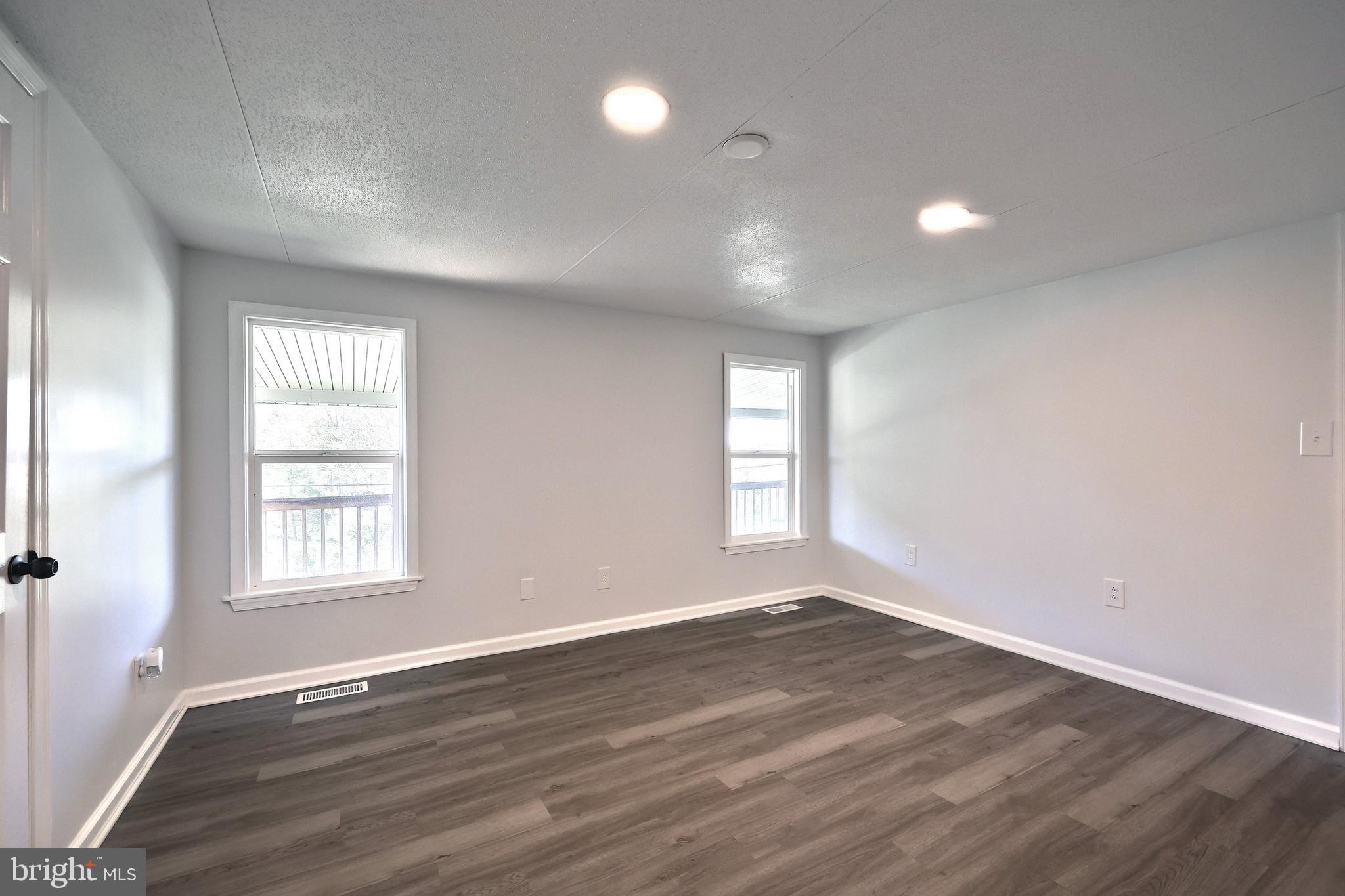 1320 Erney Road Dover, PA 17315 - Photo 24 of 35 an empty room with wooden floor and windows