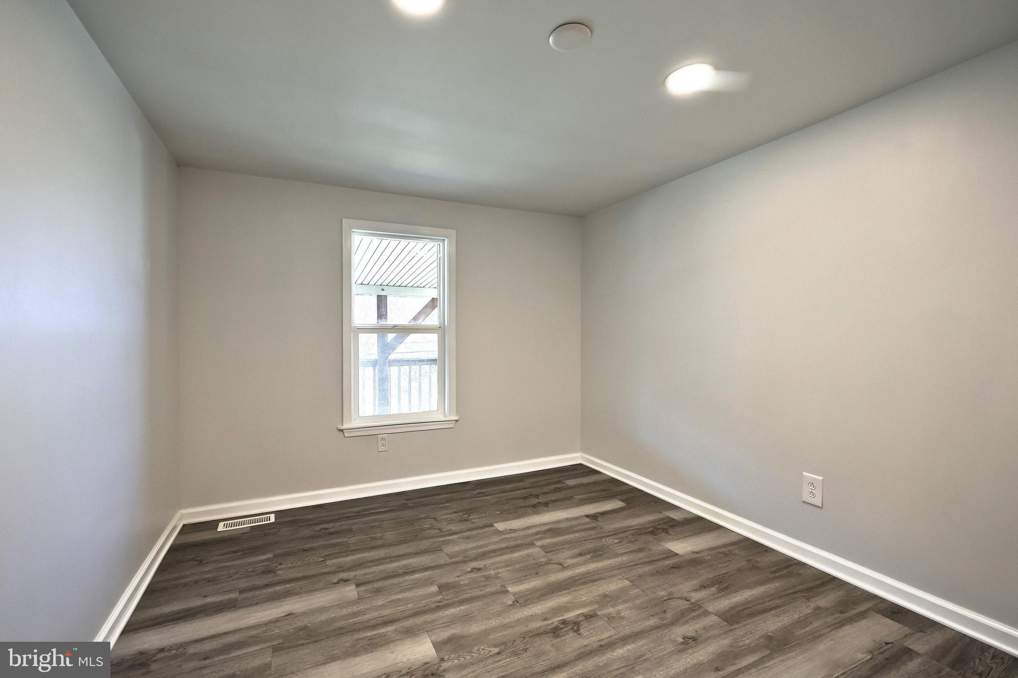 1320 Erney Road Dover, PA 17315 - Photo 30 of 35 an empty room with wooden floor and window