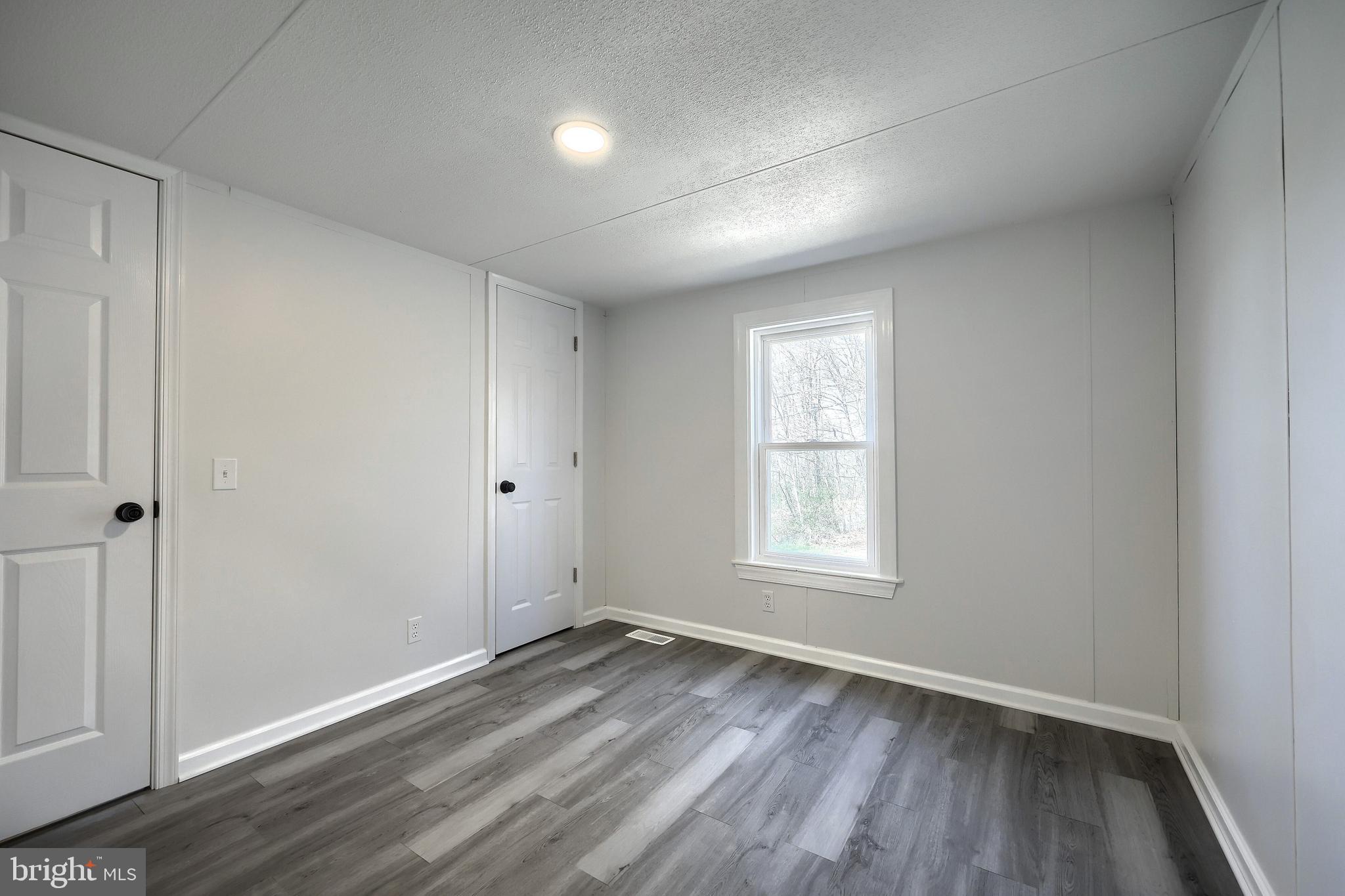 1320 Erney Road Dover, PA 17315 - Photo 33 of 35 an empty room with wooden floor and window