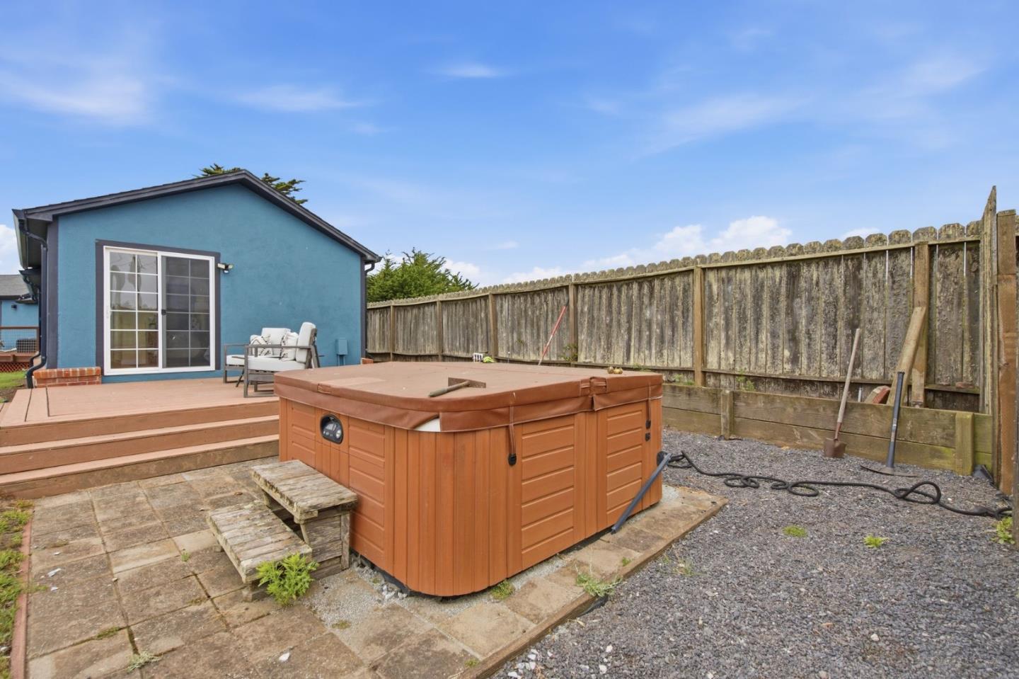 1263 Reservoir Road Pescadero, CA 94060 - Photo 11 of 66 a view of a backyard with a tub and wooden fence