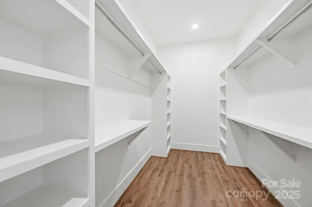a view of hallway with stairs and wooden floor